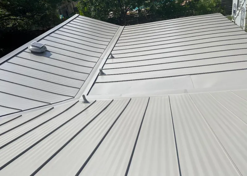 Solar attic fan installed on a metal roof for Roof Ventilation in Washington